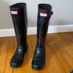Knee high black Hunter boots.